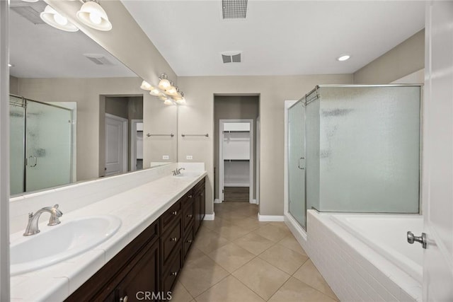 6792 Vanderbilt St, Chino, CA 91710 - bathroom featuring a stall shower, double vanity, tile patterned floors, a bath, and a walk in closet