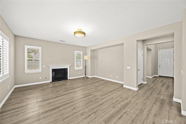 6792 Vanderbilt St, Chino, CA 91710 - unfurnished living room featuring light wood-style floors and a fireplace with flush hearth