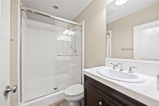 6792 Vanderbilt St, Chino, CA 91710 - bathroom featuring vanity, a stall shower, and wood finished floors