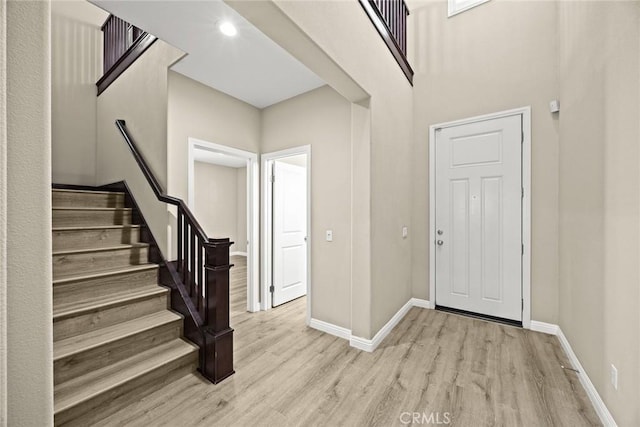 6792 Vanderbilt St, Chino, CA 91710 - entryway featuring light wood-type flooring, stairway, and a high ceiling