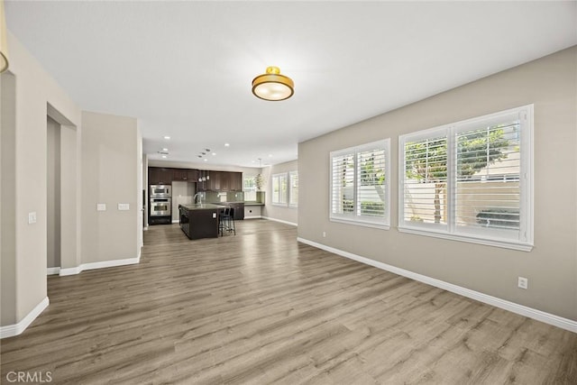 6792 Vanderbilt St, Chino, CA 91710 - unfurnished living room featuring wood finished floors and recessed lighting