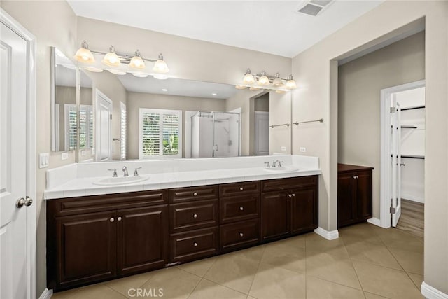6792 Vanderbilt St, Chino, CA 91710 - bathroom with a shower stall, double vanity, tile patterned flooring, and a walk in closet