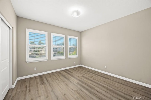 6792 Vanderbilt St, Chino, CA 91710 - unfurnished bedroom featuring multiple windows, wood finished floors, and a closet