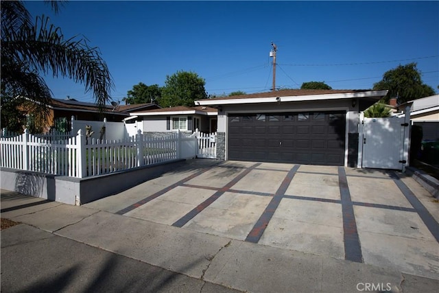 750 Durham St, La Habra, CA 90631 - view of front facade with a gate, a fenced front yard, an attached garage, and concrete driveway