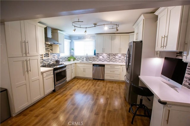 750 Durham St, La Habra, CA 90631 - kitchen with stainless steel appliances, wall chimney exhaust hood, light countertops, and backsplash