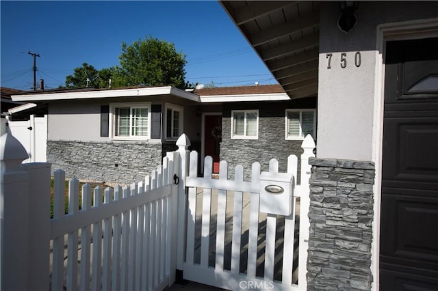 750 Durham St, La Habra, CA 90631 - doorway to property with stone siding and stucco siding