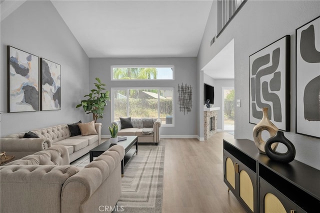 6923 Lamar Ct, Rancho Cucamonga, CA 91701 - living room featuring high vaulted ceiling, light wood-type flooring, and a fireplace
