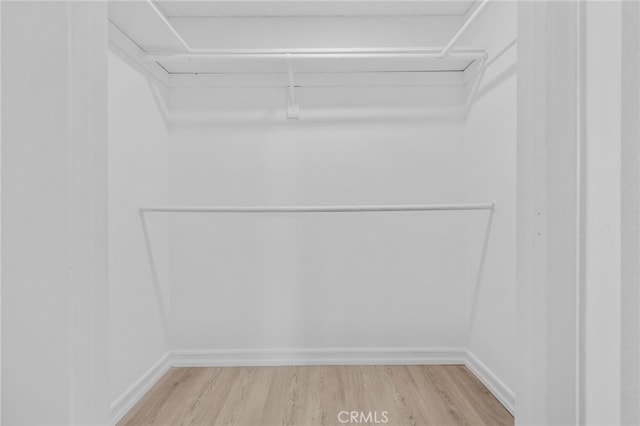 6923 Lamar Ct, Rancho Cucamonga, CA 91701 - walk in closet with wood finished floors and attic access