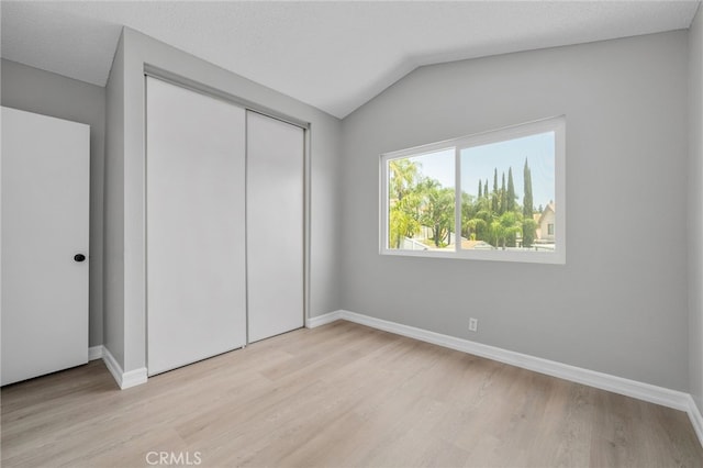 6923 Lamar Ct, Rancho Cucamonga, CA 91701 - unfurnished bedroom with light wood-style floors, a closet, and lofted ceiling