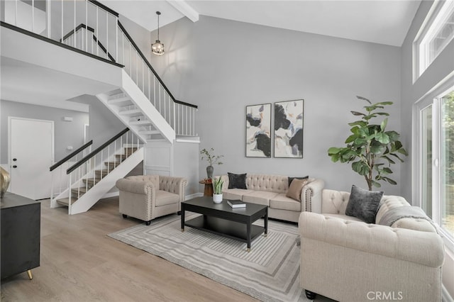6923 Lamar Ct, Rancho Cucamonga, CA 91701 - living room featuring high vaulted ceiling, stairs, wood finished floors, and beam ceiling