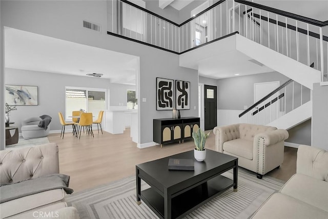 6923 Lamar Ct, Rancho Cucamonga, CA 91701 - living room featuring stairway, wood finished floors, and a high ceiling