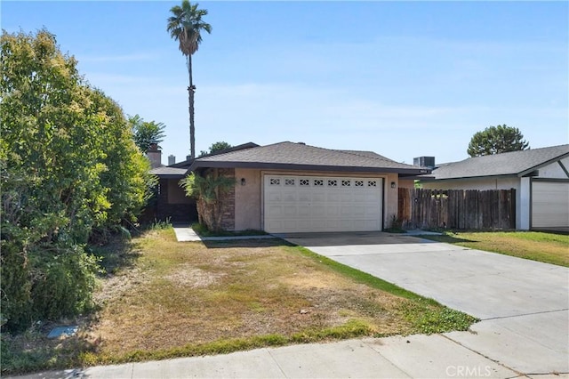 5013 Stancliff St, Bakersfield, CA 93307 - ranch-style house featuring concrete driveway, an attached garage, and stucco siding