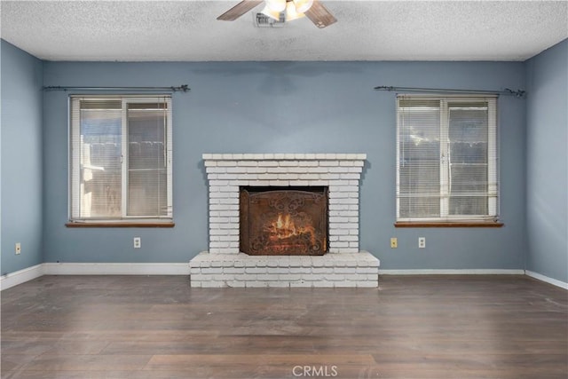 5013 Stancliff St, Bakersfield, CA 93307 - unfurnished living room with a textured ceiling, wood finished floors, ceiling fan, and a brick fireplace