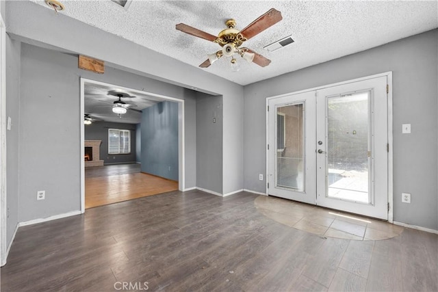 5013 Stancliff St, Bakersfield, CA 93307 - empty room with ceiling fan, wood finished floors, french doors, and a textured ceiling