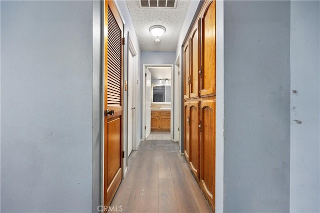 5013 Stancliff St, Bakersfield, CA 93307 - corridor with a textured ceiling and hardwood / wood-style flooring
