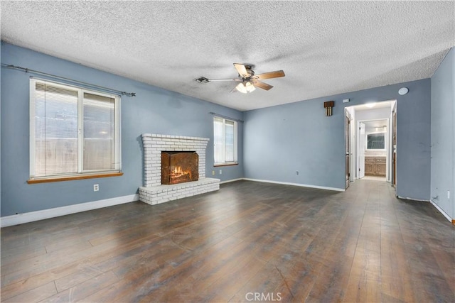 5013 Stancliff St, Bakersfield, CA 93307 - unfurnished living room featuring a ceiling fan, wood finished floors, a textured ceiling, and a fireplace