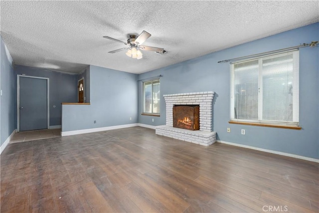 5013 Stancliff St, Bakersfield, CA 93307 - unfurnished living room with ceiling fan, wood finished floors, a textured ceiling, and a brick fireplace