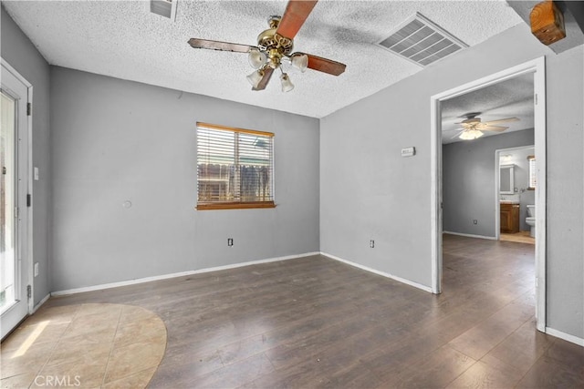 5013 Stancliff St, Bakersfield, CA 93307 - empty room with ceiling fan, a textured ceiling, and wood finished floors
