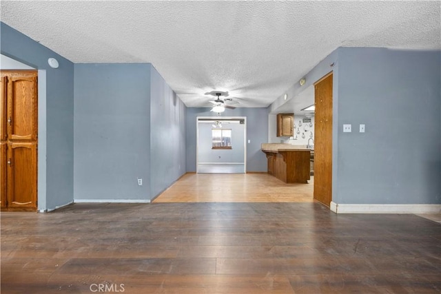 5013 Stancliff St, Bakersfield, CA 93307 - unfurnished living room with a ceiling fan, a textured ceiling, and hardwood / wood-style floors