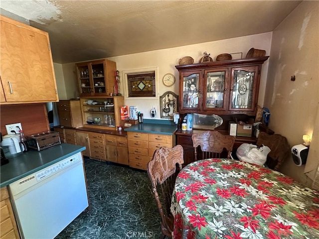 12939 3rd St, Clearlake Oaks, CA 95423 - kitchen with white dishwasher, dark countertops, and glass insert cabinets