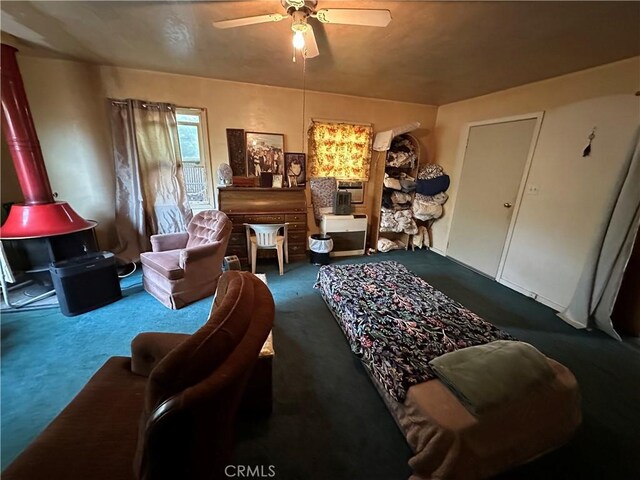 12939 3rd St, Clearlake Oaks, CA 95423 - carpeted bedroom featuring a wood stove and a ceiling fan