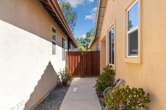 7704 Couples Way, Hemet, CA 92545 - view of side of property featuring stucco siding and a gate
