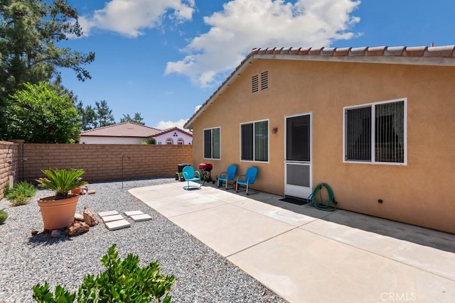 7704 Couples Way, Hemet, CA 92545 - rear view of house with a fenced backyard, a patio, and stucco siding
