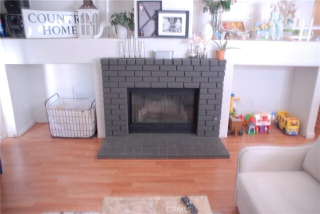 2007 Aberdeen Dr, Corona, CA 92881 - living area with wood finished floors and a brick fireplace