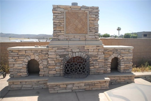 2007 Aberdeen Dr, Corona, CA 92881 - exterior view of an outdoor stone fireplace and a mountain backdrop