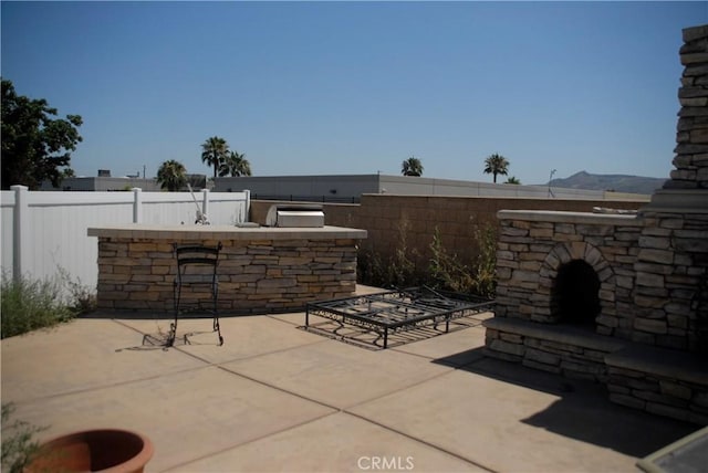 2007 Aberdeen Dr, Corona, CA 92881 - view of patio with an outdoor stone fireplace and exterior kitchen