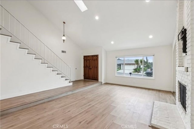 740 Great Bend Dr, Diamond Bar, CA 91765 - unfurnished living room with a brick fireplace, high vaulted ceiling, light wood-style floors, stairway, and recessed lighting