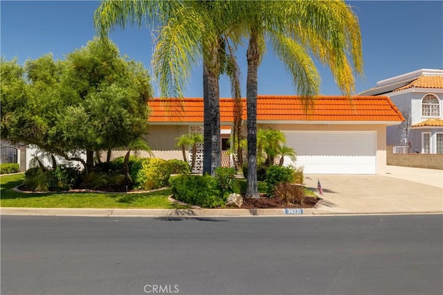 30221 Lands End Pl, Canyon Lake, CA 92587 - view of front of property with driveway, an attached garage, stucco siding, and a tile roof