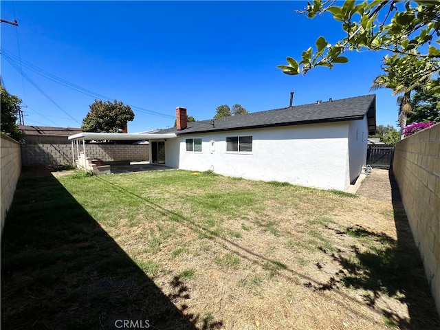 1626 S Pacific Ave, Santa Ana, CA 92704 - back of property with stucco siding, a fenced backyard, and a chimney
