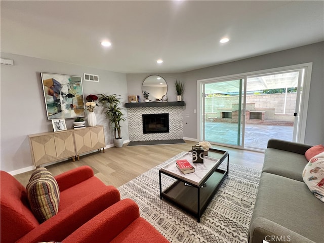1626 S Pacific Ave, Santa Ana, CA 92704 - living room with a tiled fireplace, wood finished floors, and recessed lighting