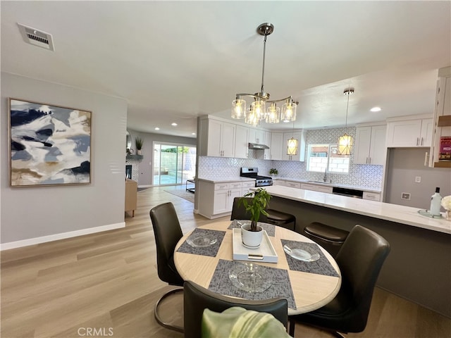 1626 S Pacific Ave, Santa Ana, CA 92704 - dining space with a chandelier, light wood-style flooring, and recessed lighting