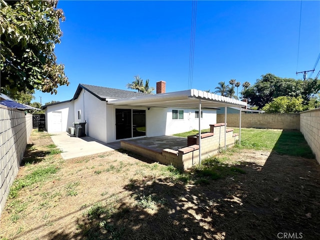 1626 S Pacific Ave, Santa Ana, CA 92704 - rear view of property featuring a patio, a fenced backyard, and a chimney