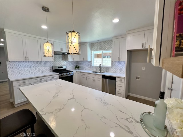 1626 S Pacific Ave, Santa Ana, CA 92704 - kitchen featuring stainless steel appliances, under cabinet range hood, decorative backsplash, light stone counters, and recessed lighting