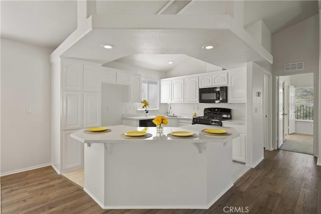 20197 Canyon View Dr, Canyon Country, CA 91351 - kitchen featuring black appliances, white cabinets, wood finished floors, and recessed lighting