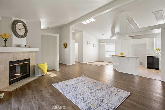 20197 Canyon View Dr, Canyon Country, CA 91351 - living room with vaulted ceiling, a tiled fireplace, and wood finished floors