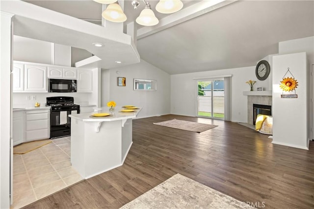 20197 Canyon View Dr, Canyon Country, CA 91351 - kitchen with black appliances, open floor plan, white cabinets, light countertops, and light wood finished floors