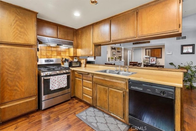 10143 Fremont Ave, Montclair, CA 91763 - kitchen with stainless steel range with gas stovetop, dishwasher, under cabinet range hood, dark wood-type flooring, and brown cabinets