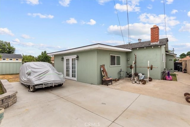 10143 Fremont Ave, Montclair, CA 91763 - rear view of property featuring french doors, a patio area, and a chimney