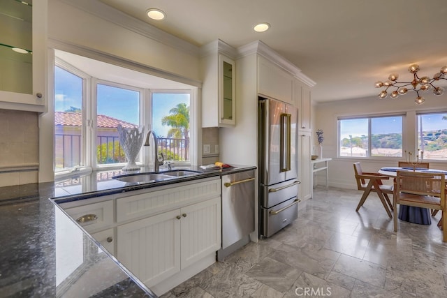 23851 Catamaran Way Unit 1, Laguna Niguel, CA 92677 - kitchen with stainless steel appliances, white cabinets, glass insert cabinets, dark stone countertops, and a chandelier