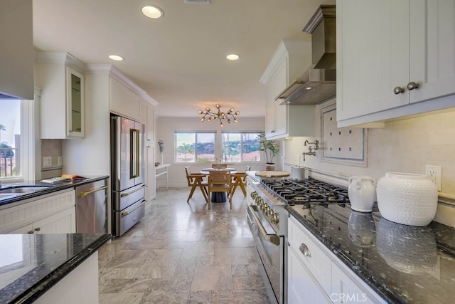 23851 Catamaran Way Unit 1, Laguna Niguel, CA 92677 - kitchen with premium appliances, wall chimney range hood, white cabinetry, recessed lighting, and glass insert cabinets