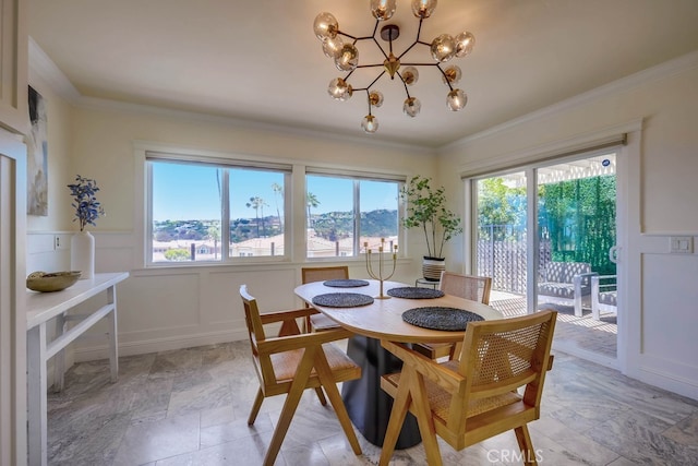 23851 Catamaran Way Unit 1, Laguna Niguel, CA 92677 - dining area with healthy amount of natural light, a chandelier, crown molding, light stone finish flooring, and a wainscoted wall