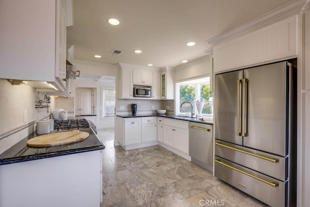 23851 Catamaran Way Unit 1, Laguna Niguel, CA 92677 - kitchen with appliances with stainless steel finishes, white cabinetry, ornamental molding, glass insert cabinets, and recessed lighting