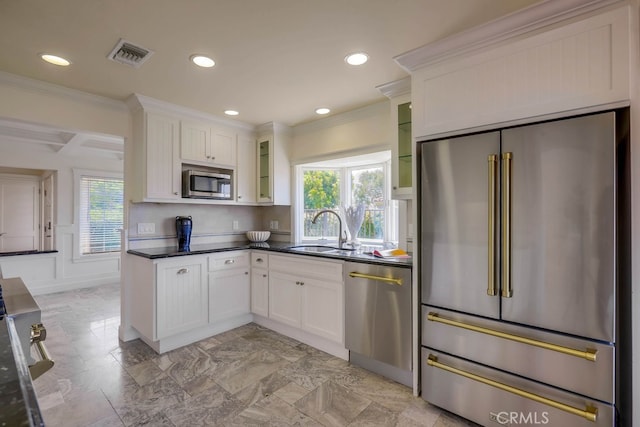 23851 Catamaran Way Unit 1, Laguna Niguel, CA 92677 - kitchen with stainless steel appliances, plenty of natural light, recessed lighting, glass insert cabinets, and ornamental molding