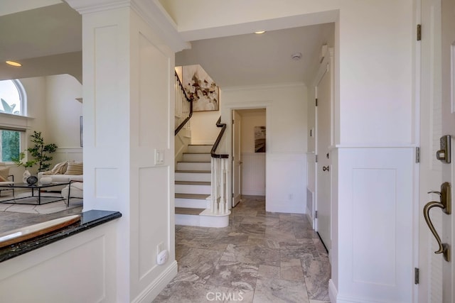 23851 Catamaran Way Unit 1, Laguna Niguel, CA 92677 - foyer with stairs, light marble finish floors, a decorative wall, and wainscoting