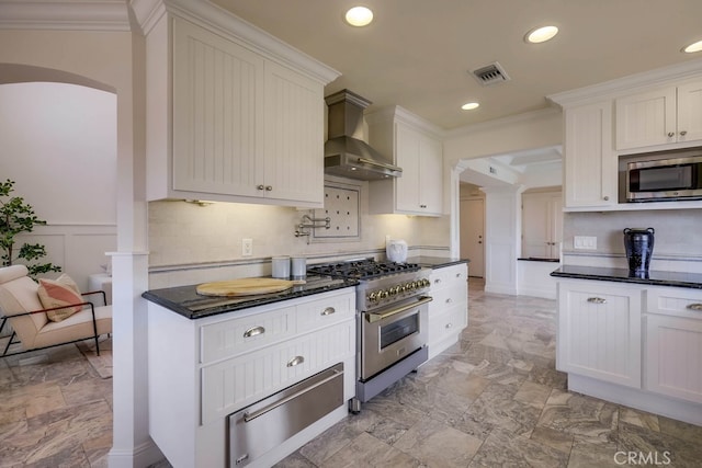 23851 Catamaran Way Unit 1, Laguna Niguel, CA 92677 - kitchen with a warming drawer, wall chimney exhaust hood, stainless steel appliances, crown molding, and recessed lighting