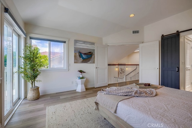 23851 Catamaran Way Unit 1, Laguna Niguel, CA 92677 - bedroom featuring a barn door, light wood-type flooring, lofted ceiling, and recessed lighting
